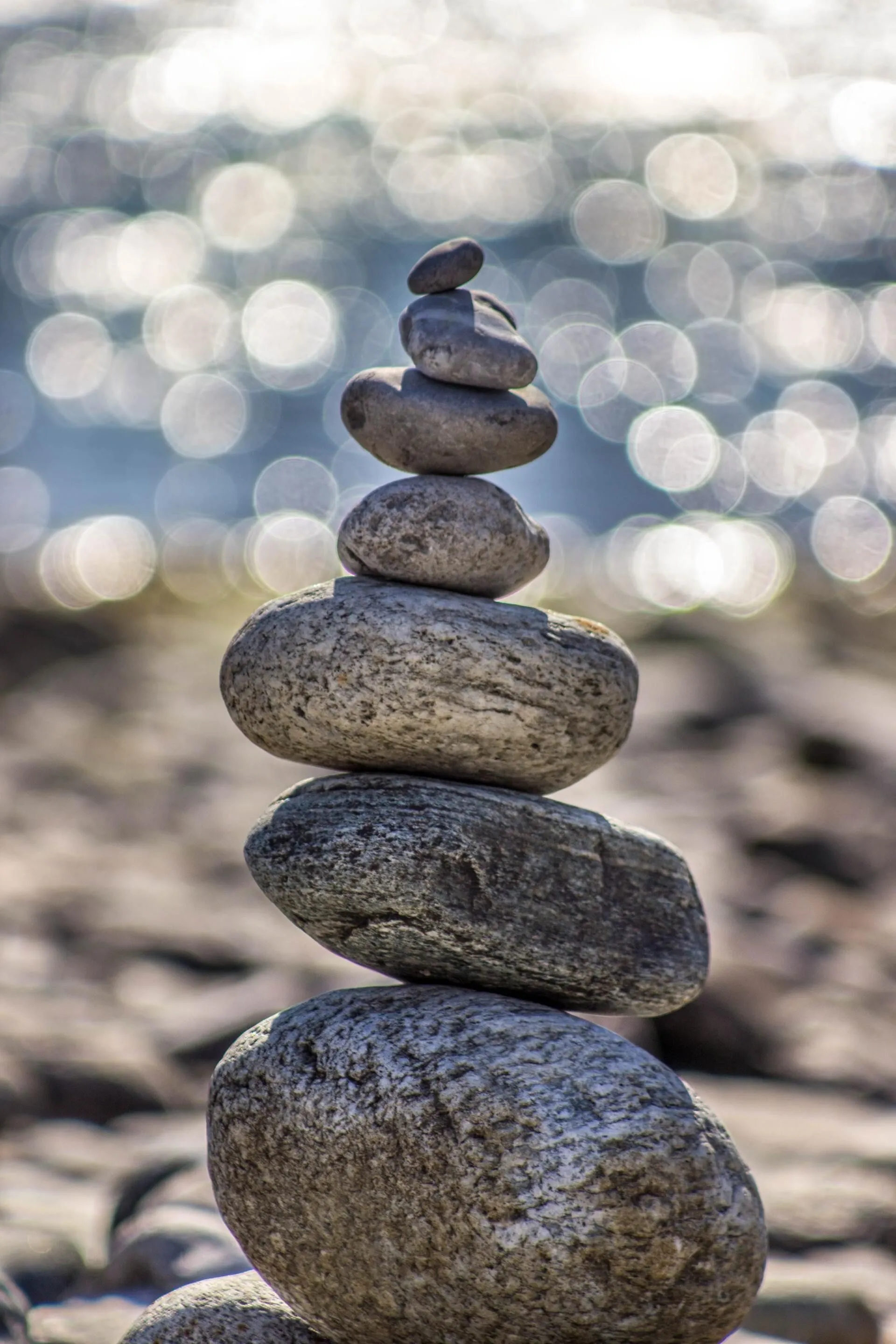 Stacked balancing stones beside the water