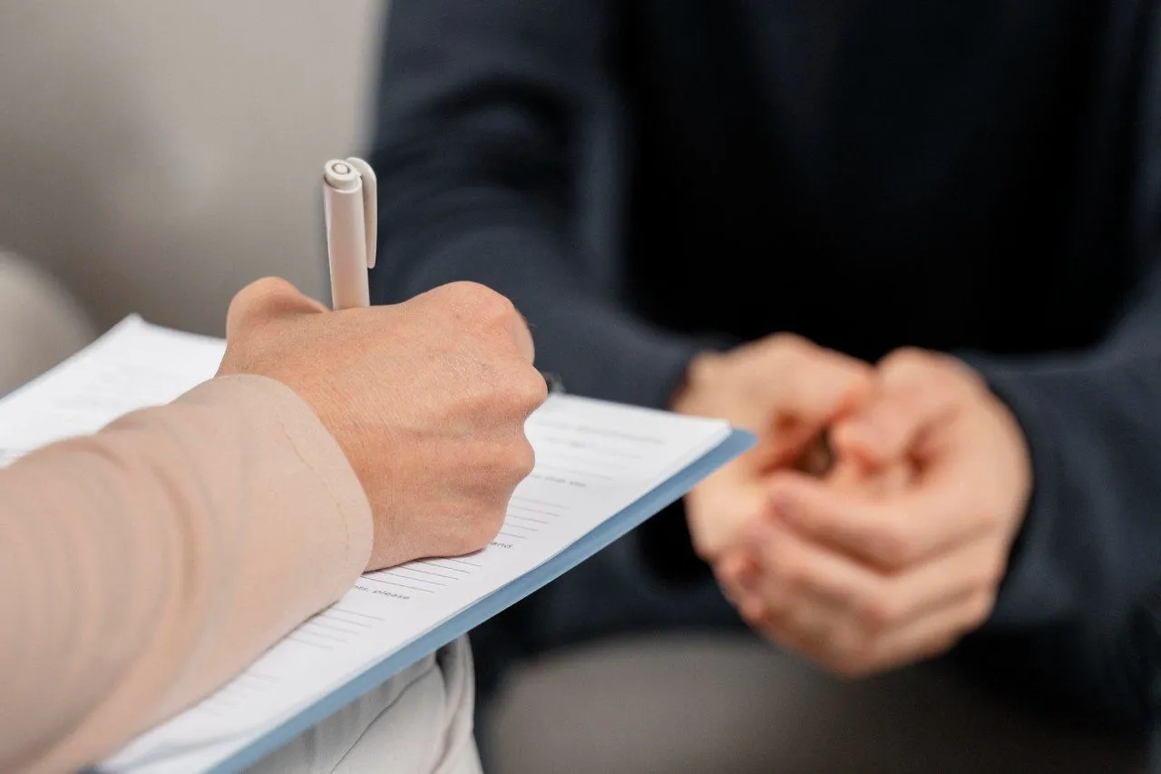 Therapist taking notes during a counseling session