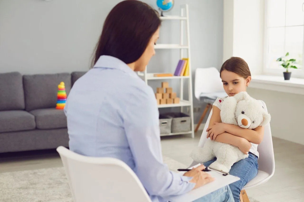 A therapist working with a child during a play therapy session